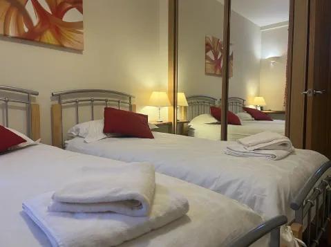 Twin bedroom with fitted wardrobes