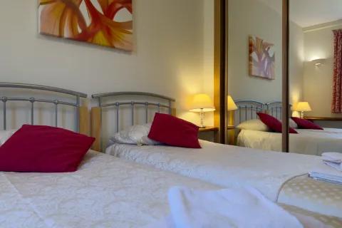 Twin bedroom with fitted wardrobes